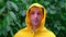 close up front view young man Man yellow raincoat under heavy rain bad weather