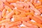 Close up of frozen baby carrots on white background