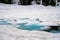 Close up of a frozen Emerald Lake in Lassen National Park with blue ice and snow