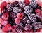 Close up of frozen mixed fruit - berries - red currant, cranberry, raspberry, blackberry, bilberry, blueberry, black currant