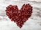 Close-up of fruit with blur / bokeh effect, pomegranate seeds laid out in the shape of a heart, symbolizing love.