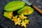 Close up of fruit star Averrhoa carambola on the black stone. Top view close up details.