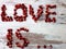 close-up of fruits with blur / bokeh effect, pomegranate seeds laid out in words symbolizing love.