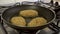Close-up of frying juicy cutlets in breadcrumbs in a pan.Pan movement to distribute the oil evenly.
