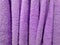 Close-up Full frame photo of warm purple sweaters on hangers in store.