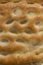Close-up, full page image of a slice of focaccia, a typical ital