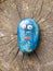 Close up of funny cartoon painted children blue stone with eyes