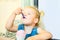 Close up funny, cute and happy toddler baby girl eating berry ice-cream from paper bowl with emotion and delight in cafe. Taste an