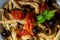 Close-up of Fusilli al ferro with black olives and cherry tomatoes