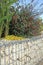 Close-up of a gabion support wall with wire mesh reinforcement and pebbles