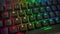 close up of a gaming computer keyboard, with backlit black keys changing color, RGB light, 4k