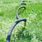 Close up of garden hose in grass, selective focus,