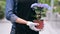 Close up of gardener holding pot with hydrangea