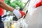 Close-up of a gas station worker working with a gasoline injector pump. to refuel Petrol pump - refueling Car refueling station