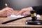 Close-up Of A Gavel On Wooden Desk