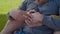 Close-up of gay couple caressing hands outdoors