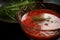 close-up of gazpacho, with droplets of juice and herbs visible