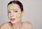 Close up gentle sophisticated mysterious girl in a moisturizing mask with a fresh cucumber on the face