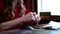 Close up of gesturing hands of a business woman sitting at laptop. Focus on woman\'s hands gesturing at a online meeting