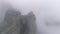 Close-up of giant rocks with trees in morning fog. Shot. Majestic mountain landscape.