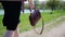 close-up of a girl carrying a handbag in her hand in summer outside on a sunny day