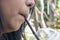 Close up of a girl drinking a water from straw in the hot time.