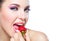 Close up of girl eating strawberry