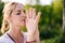 Close-up of of girl with emotion of serenity and tranquility performing Namaste gesture