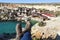 Close up of girl feet wearing hiking boots and enjoying breathtaking landscape of Popeye Village, Malta