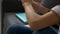 Close up of a girl folds a book on a sofa and sits comfortably. A woman in blue jeans finished reading a book