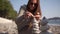 Close-up girl, hand folds a pyramid of stones on the seashore