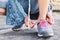 Close up girl hands tying shoelace on shoes