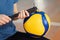 Close up of girl inflating new volleyball ball with hand pump on court before training