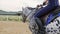 Close-up of girl legs riding on a horse on the field during sunset, slow motion