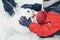 Close-up of a girl makes a face to a snowman. Winter outdoor games