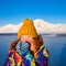 Close-up of a girl in a rainbow jacket and yellow knitted cap on the background Svalbard Longyearbyen of mountain north p