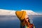 Close-up of a girl in a rainbow jacket and yellow knitted cap on the background Svalbard Longyearbyen of mountain north p