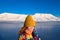 Close-up of a girl in a rainbow jacket and yellow knitted cap on the background Svalbard Longyearbyen of mountain north p