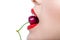 Close up of girl with red lips eating a berry