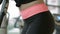 Close up of girl\'s buttocks and body during workout on orbitrek