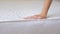 Close up of a girl's hand checks the rigidity of a new comfortable orthopedic white mattress for the bed. Female