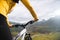 A close-up of the girl`s hand cyclist on the handlebars of a mountain bike against the backdrop of epic rocks and