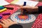 Close-up of girl`s hands coloring a mandala