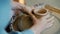 Close-up of girl`s hands making pot on pottery wheel in studio busy with creative activity