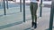 Close-up of girl`s legs on the open area for workout. Woman shakes the press hanging on the horizontal bar