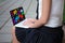 Close up of girl in school uniform using laptop with media icons