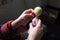 Close-up girl sews hand to her handmade crochet doll