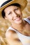 Close up of girl in straw hat against rye field