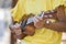 Close up of girl with ukulele in yellow shirt .