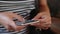 Close up of girl using smartphone in cafe outdoor texting on mobile phone. Hands with mobile phone.